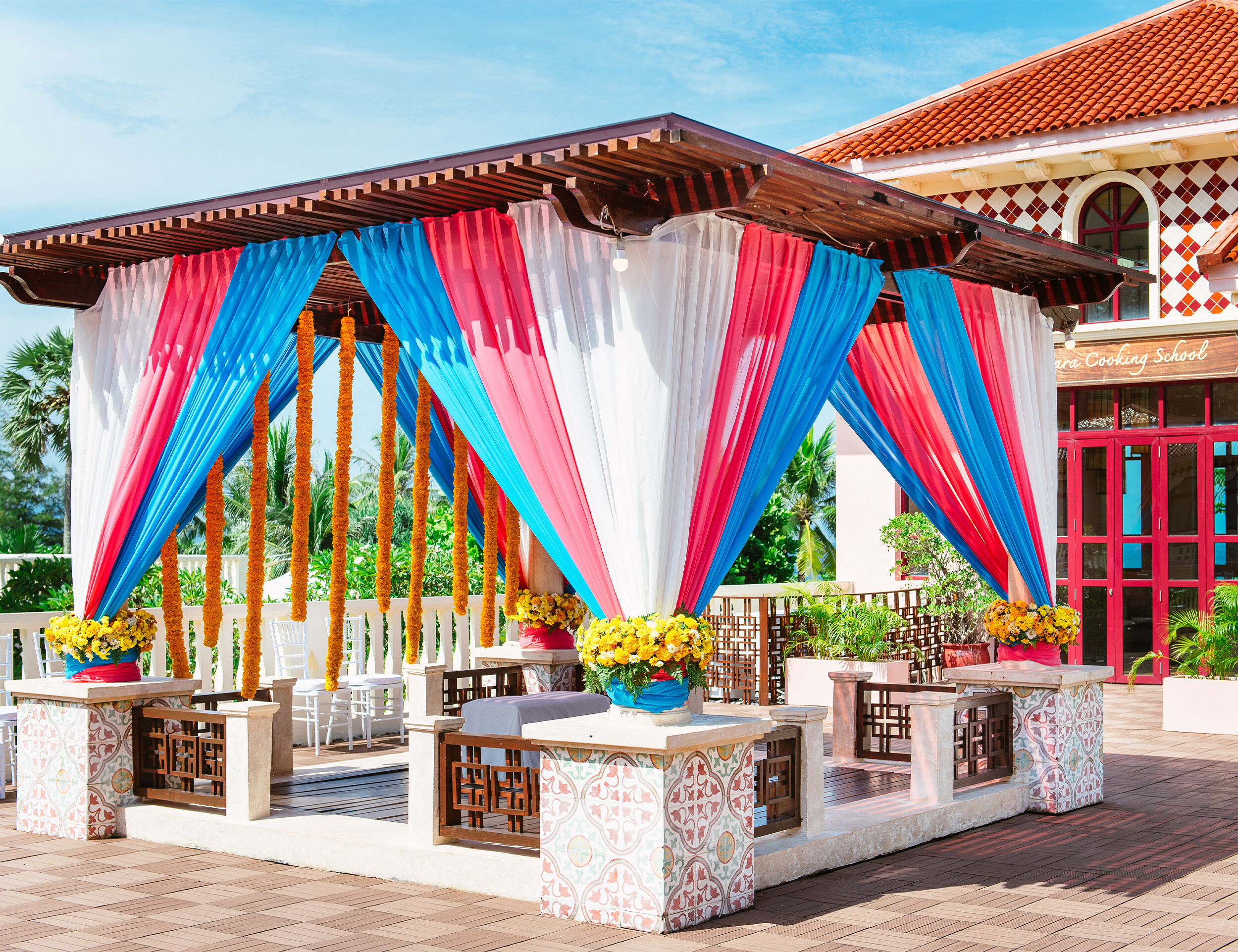 Vibrant Indian wedding venue with stunning colorful decorations and floral arrangements.